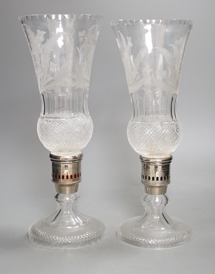 A pair of thistle engraved and cut glass storm lamps - 35cm tall